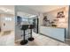 Kitchen with breakfast bar, white cabinets and view of entryway at 11919 E Yale Ave, Aurora, CO 80014