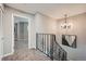 Upper hallway with chandelier and staircase access at 11919 E Yale Ave, Aurora, CO 80014