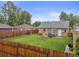 Backyard features a large grassy area, privacy fence, and patio furniture at 2681 Leyden St, Denver, CO 80207
