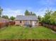 Fully fenced backyard featuring a grassy lawn and patio with outdoor seating at 2681 Leyden St, Denver, CO 80207