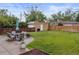 Spacious backyard featuring a patio with outdoor seating, lush lawn, and a privacy fence at 2681 Leyden St, Denver, CO 80207