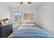 Bedroom showcasing a bed, dresser, window, and hardwood floors at 2681 Leyden St, Denver, CO 80207