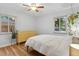 Bright bedroom with hardwood floors, natural light, and a yellow dresser at 2681 Leyden St, Denver, CO 80207