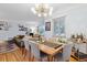 Open-concept dining area with modern chandelier, stylish furniture and hardwood floors at 2681 Leyden St, Denver, CO 80207