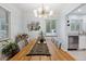 Bright dining area featuring a wooden table with seating, an elegant chandelier, and a bar cart at 2681 Leyden St, Denver, CO 80207