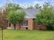 Charming brick home with mature trees in the yard at 2681 Leyden St, Denver, CO 80207