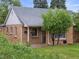 Charming brick home with a well-maintained lawn, mature trees and cozy front porch at 2681 Leyden St, Denver, CO 80207