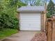 The garage has a white door, brick siding, and a paved driveway at 2681 Leyden St, Denver, CO 80207