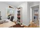 Bright home office with a desk, bookshelves, and French doors leading to the yard at 2681 Leyden St, Denver, CO 80207