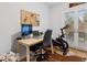 Office space with a work station with a view of the backyard, and an exercise bike at 2681 Leyden St, Denver, CO 80207