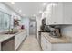 Modern kitchen with white cabinetry, stainless steel appliances, and granite countertops at 2681 Leyden St, Denver, CO 80207