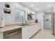 Well-lit kitchen features white cabinets, granite countertops, stainless steel appliances, and modern fixtures at 2681 Leyden St, Denver, CO 80207