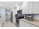 Bright kitchen with white cabinets, stainless steel appliances, and granite countertops at 2681 Leyden St, Denver, CO 80207