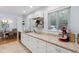 Kitchen with white cabinets and countertops, stainless steel appliances, and fruit basket at 2681 Leyden St, Denver, CO 80207
