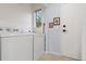 Functional laundry room with white washer and dryer units and neutral flooring at 2681 Leyden St, Denver, CO 80207