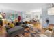 Bright and airy living room features hardwood floors, large windows and stylish decor at 2681 Leyden St, Denver, CO 80207
