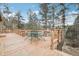 Outdoor deck area with dining table and seating, surrounded by lush forest and mountain views at 30930 Bear Cub Trl, Conifer, CO 80433