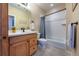 Bathroom with shower/tub combo and wood vanity at 2543 Eastview Dr, Castle Rock, CO 80104