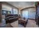 Bonus room with leather sofa, coffee table, and ample natural light at 2543 Eastview Dr, Castle Rock, CO 80104