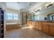 Main bathroom with double vanities, a large soaking tub, and a walk-in shower at 2543 Eastview Dr, Castle Rock, CO 80104