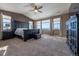 Main bedroom with high ceilings, large windows, and a ceiling fan at 2543 Eastview Dr, Castle Rock, CO 80104