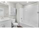 Well-lit bathroom featuring modern sink, cabinet, and tub with white tile surround at 11294 Bella Vita Dr, Broomfield, CO 80020