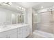 Bright bathroom featuring double sink vanity, modern fixtures, and glass enclosed shower at 11294 Bella Vita Dr, Broomfield, CO 80020