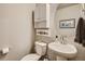 Charming powder room featuring a pedestal sink, decorative art, and a round mirror at 11294 Bella Vita Dr, Broomfield, CO 80020
