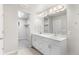 Bright bathroom featuring double sink vanity, modern fixtures, and walk-in closet at 11294 Bella Vita Dr, Broomfield, CO 80020