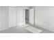 Bedroom with open door, neutral carpet, and spacious closet with sliding doors at 11294 Bella Vita Dr, Broomfield, CO 80020