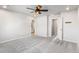 Neutral bedroom featuring gray carpet, white walls, a ceiling fan, and multiple doorways at 11294 Bella Vita Dr, Broomfield, CO 80020