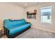 Inviting bedroom with a blue futon and decoratively displayed medals at 11294 Bella Vita Dr, Broomfield, CO 80020