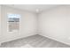 Bright bedroom featuring a large window, plush carpet, and neutral walls at 11294 Bella Vita Dr, Broomfield, CO 80020