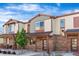 Townhome exterior showcasing stone accents, covered entry, and professional landscaping at 11294 Bella Vita Dr, Broomfield, CO 80020