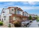 Exterior facade of multi-Gathering unit featuring stone veneer, covered porch, and meticulous landscaping at 11294 Bella Vita Dr, Broomfield, CO 80020