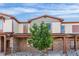 Attractive townhome facade with stone details, covered entrance, and a well-maintained yard at 11294 Bella Vita Dr, Broomfield, CO 80020