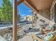 Charming front porch with wooden chairs, colorful cushions, and stone accents at 11294 Bella Vita Dr, Broomfield, CO 80020