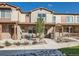 Charming townhome with stone accents, front porch, and well-manicured landscaping at 11294 Bella Vita Dr, Broomfield, CO 80020
