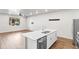 Open-concept kitchen featuring a central island with stainless steel dishwasher and hardwood floors at 11294 Bella Vita Dr, Broomfield, CO 80020