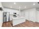 Bright, open kitchen with stainless steel appliances, white cabinets and central island at 11294 Bella Vita Dr, Broomfield, CO 80020