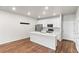 Bright, open kitchen with white cabinets, a large island, and stainless steel appliances at 11294 Bella Vita Dr, Broomfield, CO 80020