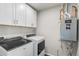 A functional laundry room with modern washer, dryer, and ample cabinet storage at 11294 Bella Vita Dr, Broomfield, CO 80020