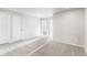 Bright loft area with neutral carpeting, two entry doors, and natural light at 11294 Bella Vita Dr, Broomfield, CO 80020