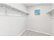 Bright walk-in closet features natural light and convenient shelving for optimal storage solutions at 11294 Bella Vita Dr, Broomfield, CO 80020