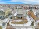 Aerial view of a fenced backyard, patio, and houses in a vibrant neighborhood setting at 160 Pipit Lake Way, Erie, CO 80516