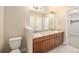 Bathroom featuring vanity with double sinks and granite countertop at 160 Pipit Lake Way, Erie, CO 80516