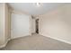 Neutral bedroom features carpet, built-in closet, and an entry to another room at 160 Pipit Lake Way, Erie, CO 80516