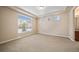 Spacious bedroom with carpet, tray ceiling, and ample natural light from multiple windows at 160 Pipit Lake Way, Erie, CO 80516