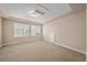 Bonus room with tray ceiling, carpet, and view to exterior of home at 160 Pipit Lake Way, Erie, CO 80516