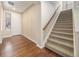 Inviting entryway with hardwood floors, staircase, and natural light from the front door window at 160 Pipit Lake Way, Erie, CO 80516